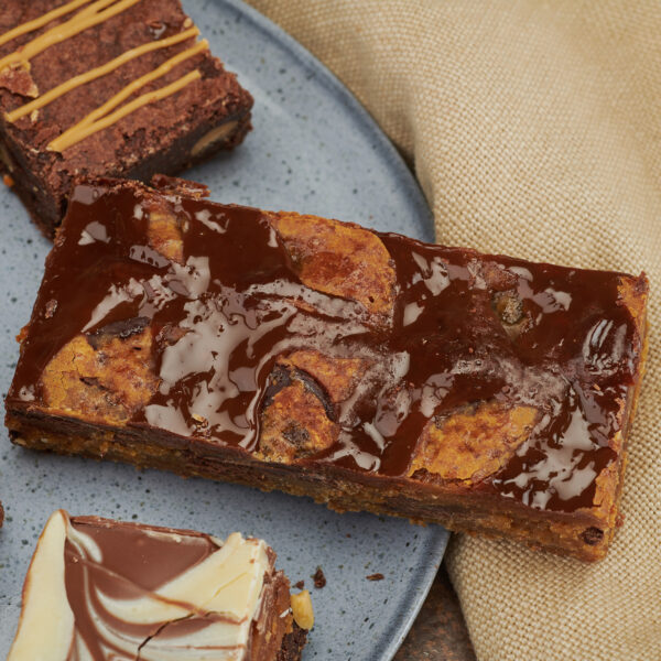 Assorted chocolate brownies on a grey plate.