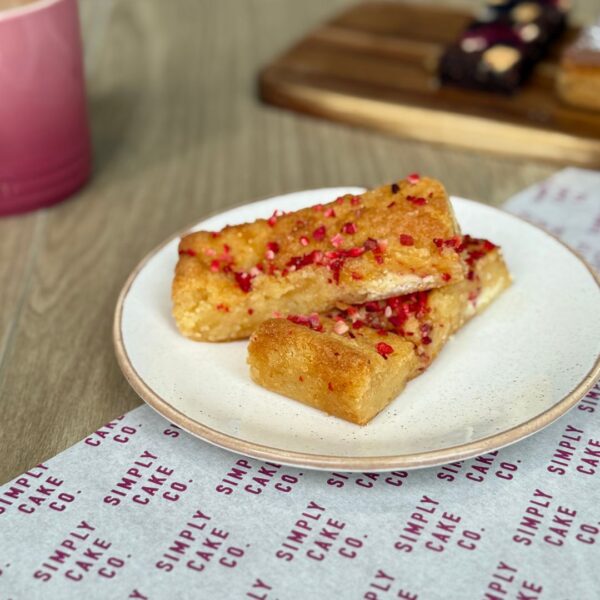 Blondies with sprinkles on a white plate.