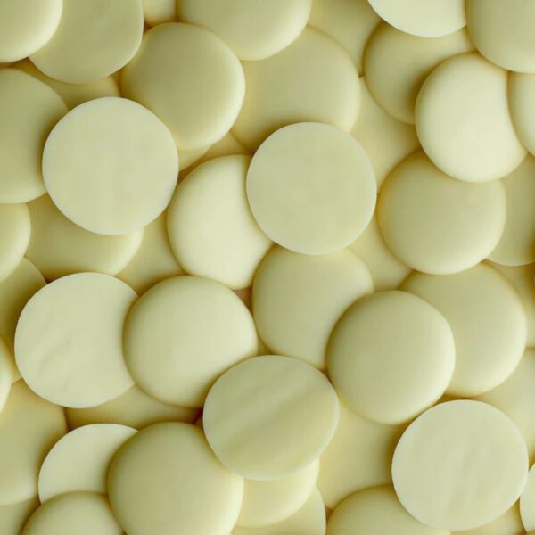 White chocolate drops stacked closely together.